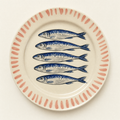 Ivory ceramic dinner plate hand-painted with five sardines and a coral brush-stroke rim