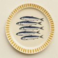 Ivory ceramic dinner plate hand-painted with five sardines and a saffron brush-stroke rim