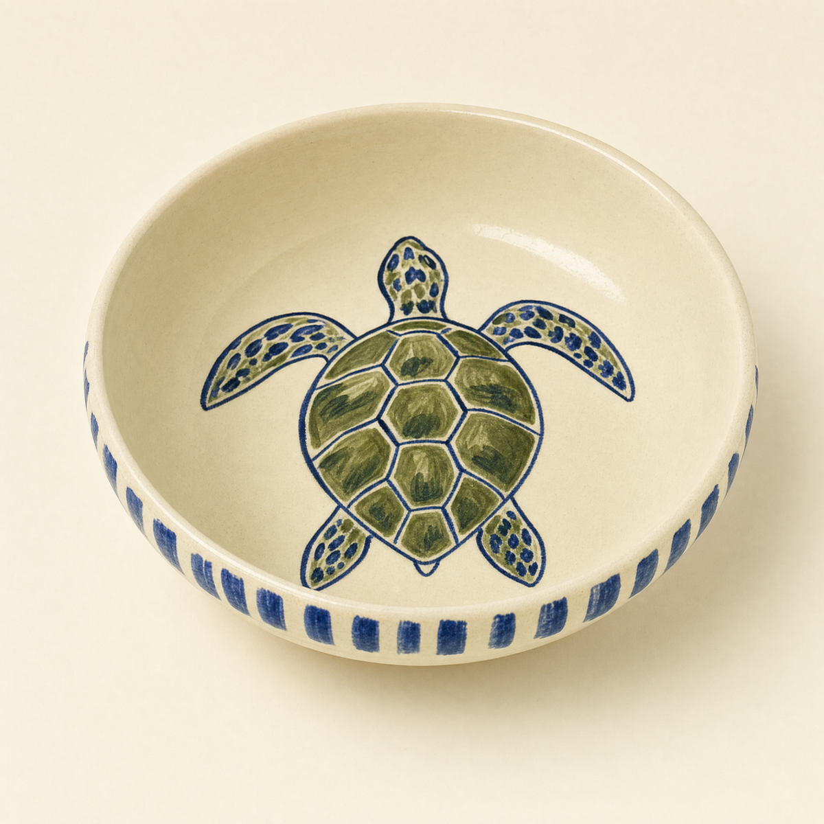 Deep ivory ceramic supper bowl hand-painted with a sea turtle and a cobalt brush-stroke rim